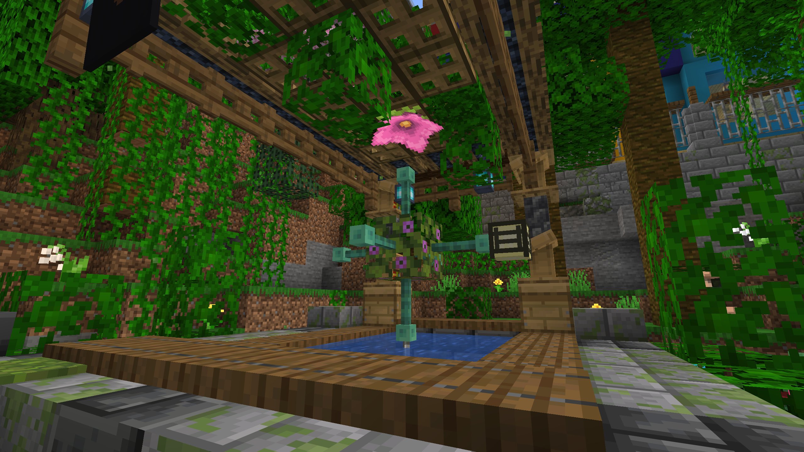 A quiet covered courtyard with a small blue pool, a flower-topped pillar, and a leafy canopy overhead.